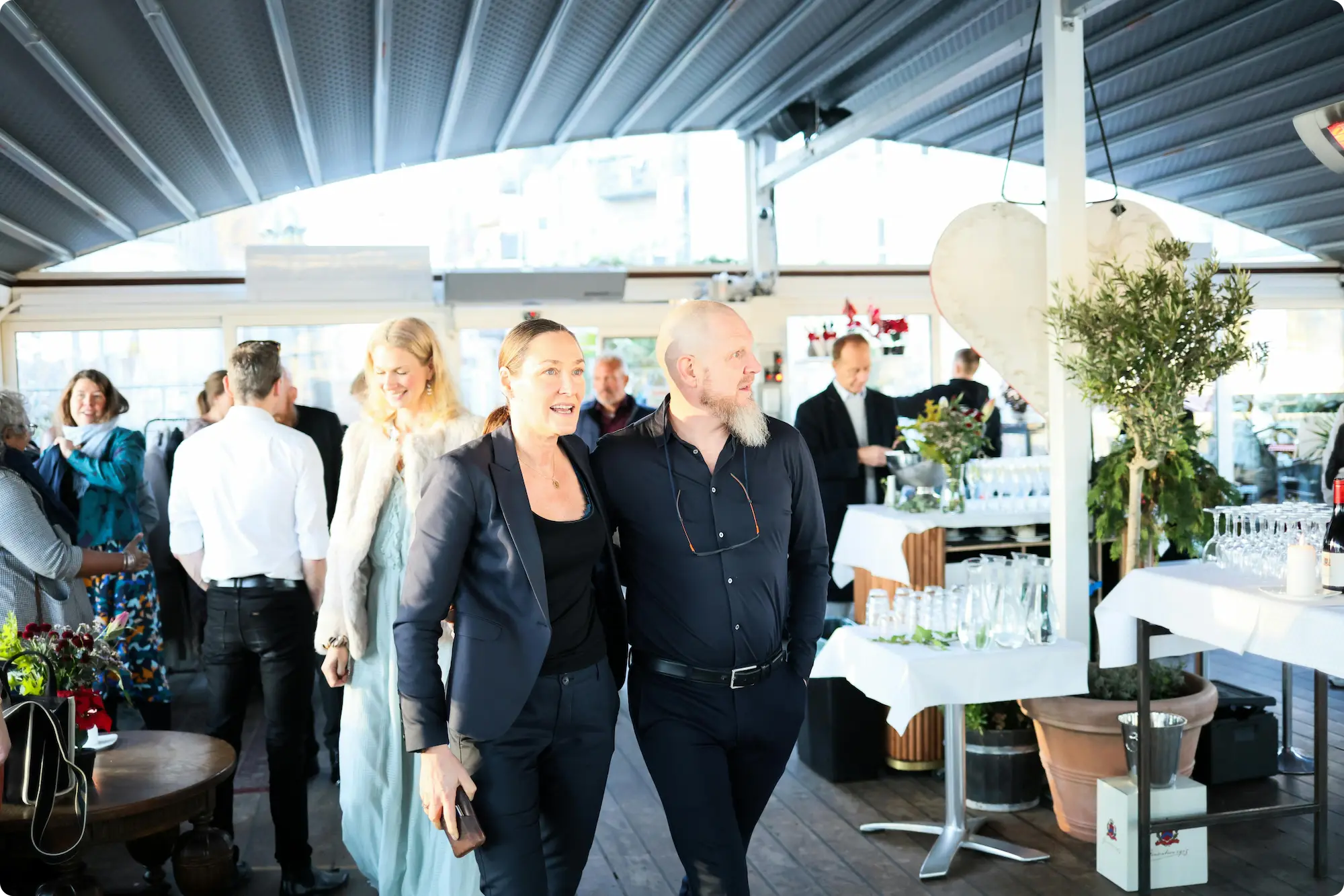 Two people standing close at an event